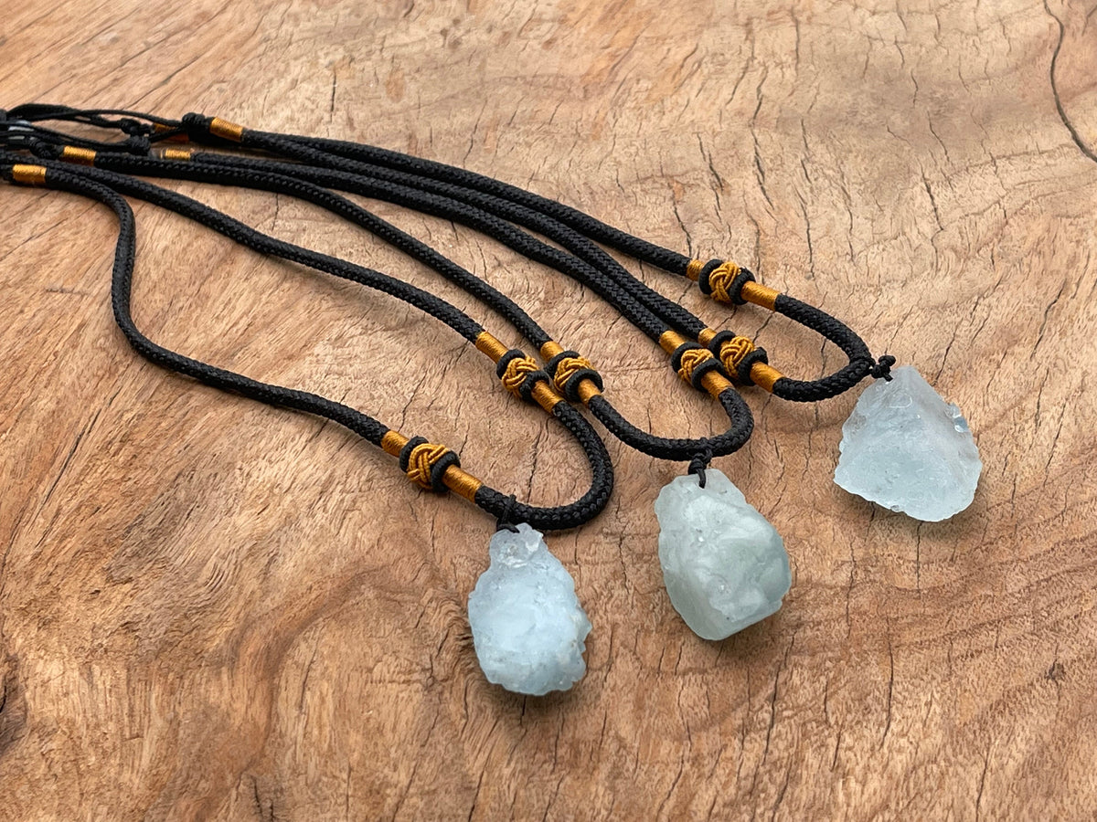 Aquamarine crystal necklace from GemstoneGO featuring a polished healing stone pendant on a silver chain.