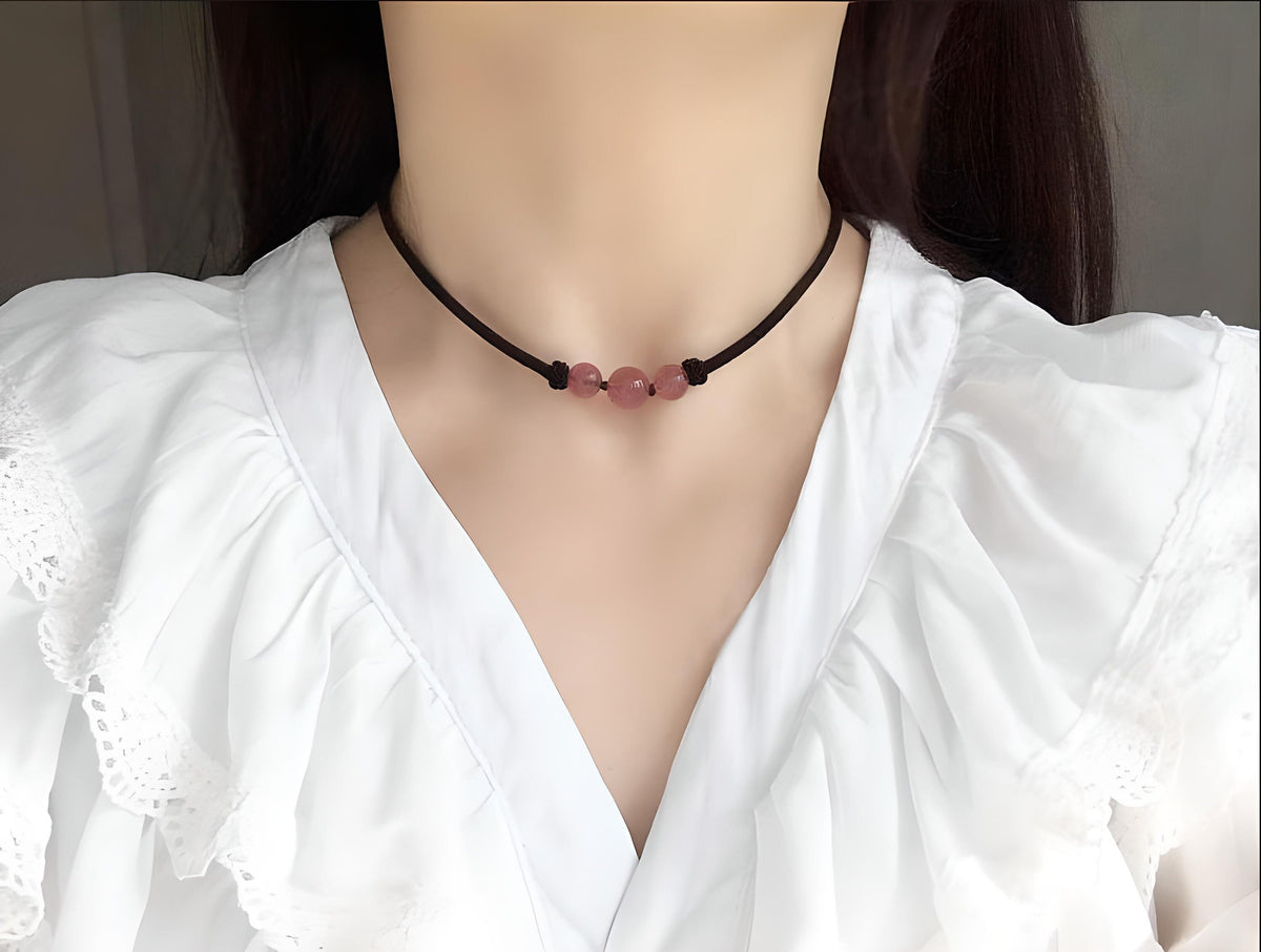 Strawberry quartz sphere crystal necklace with a polished, round gemstone pendant on a delicate chain, showcasing vibrant pink tones.