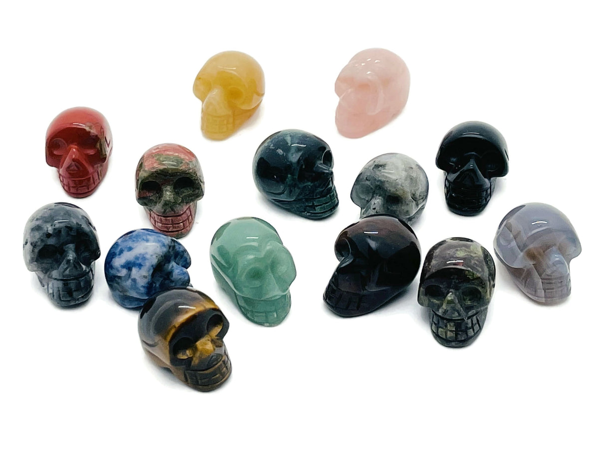 Colorful gemstone crystal skull carving, 25mm loose stone with intricate skull design, perfect for Halloween or jewelry making.