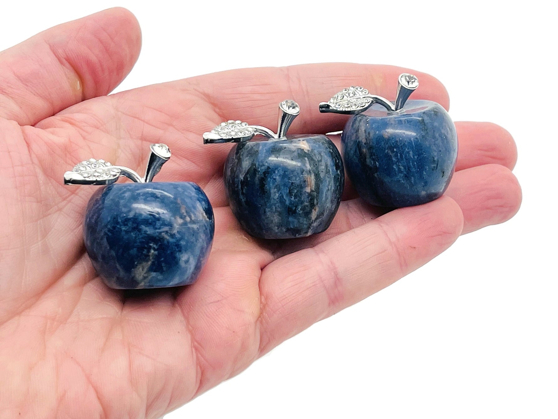 Sodalite apple-shaped crystal carving from GemstoneGO, 30mm, showcasing blue and white mineral patterns on a polished surface.