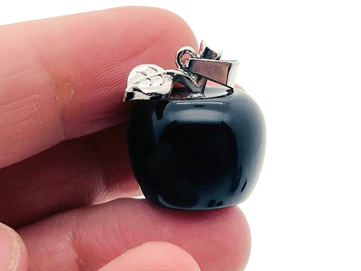 Mini obsidian apple crystal pendant by GemstoneGO featuring a sleek black stone carved into an apple shape.
