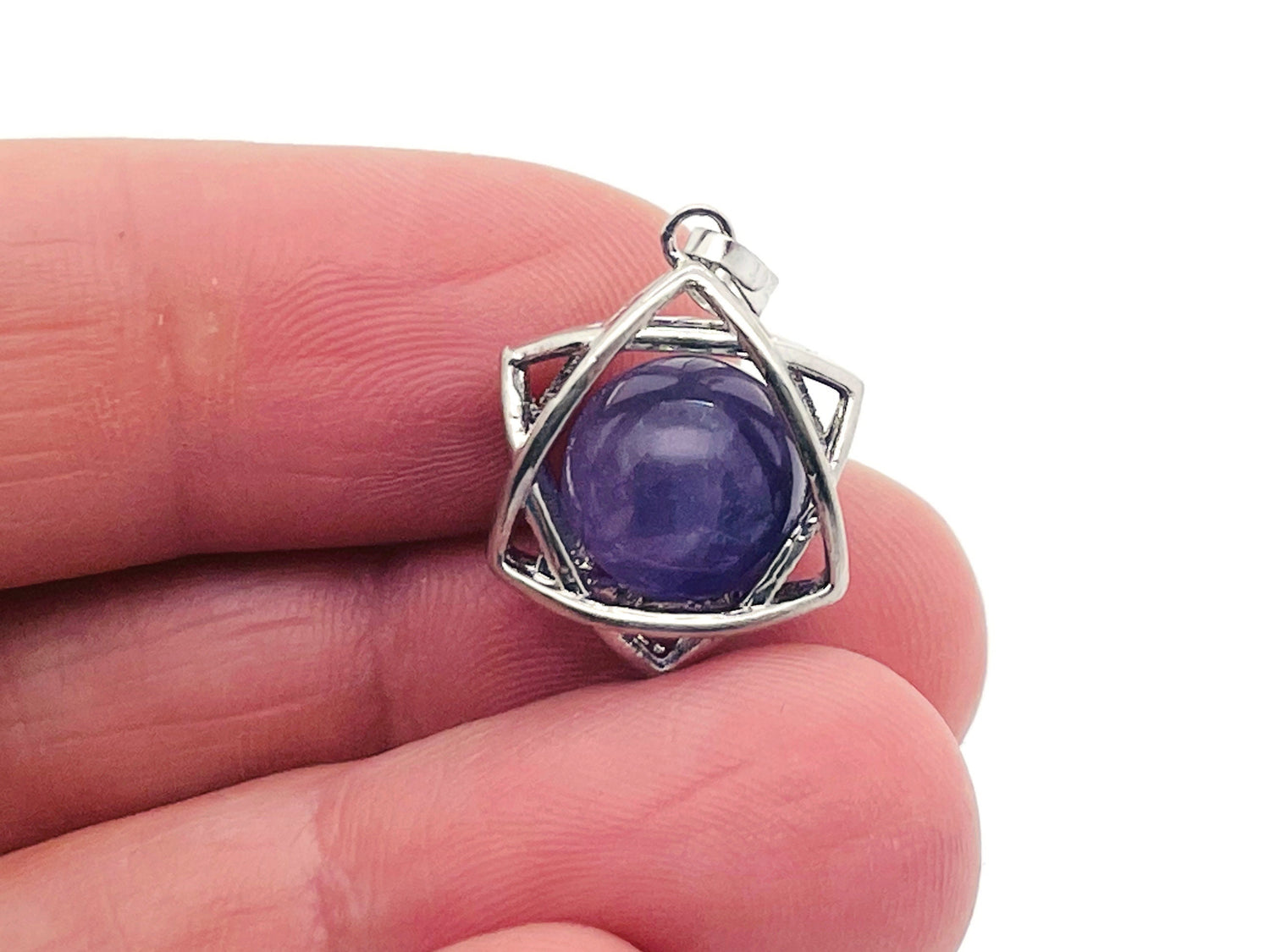Amethyst crystal pendant jewelry by GemstoneGO featuring a polished purple gemstone on a silver chain.