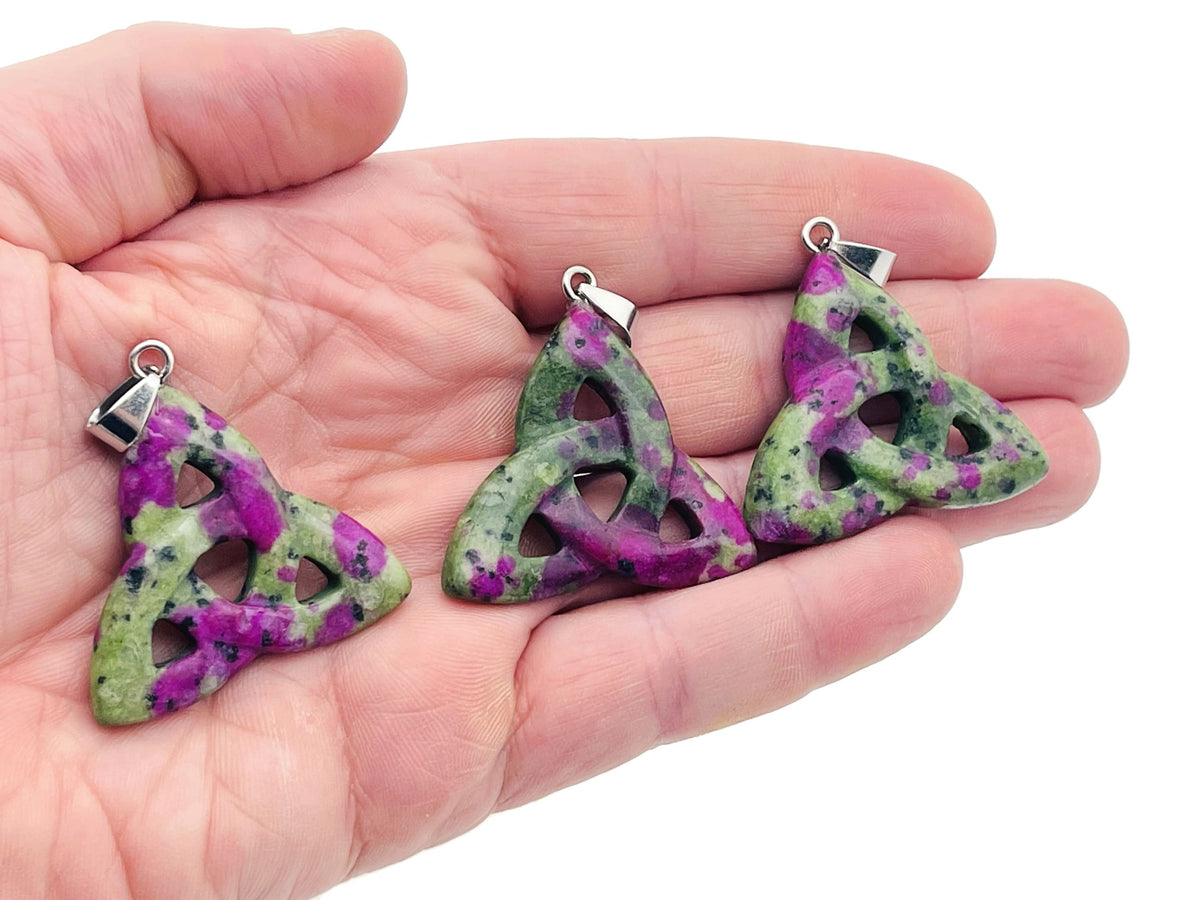Ruby Zoisite Celtic Knot crystal pendant from GemstoneGO featuring a Trinity Crystals design and intricate Celtic knot detail.