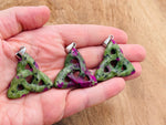 Ruby Zoisite Celtic Knot crystal pendant featuring intricate Trinity Crystals design, showcasing vibrant red and green gemstone details.