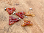 Carnelian Celtic knot crystal pendant by GemstoneGO featuring a Trinity Crystals design on a silver chain.