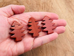 Handmade red Jasper pine tree carving gemstone from GemstoneGO, detailed tree sculpture on a polished red Jasper stone.