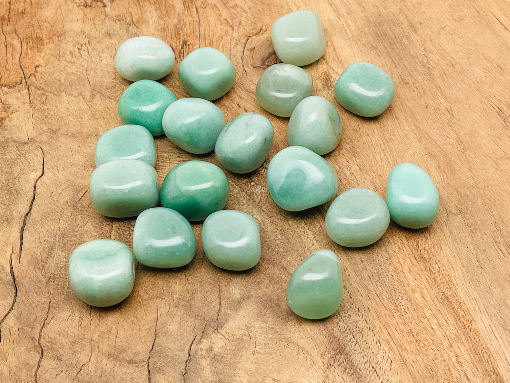 Aventurine tumbled stone from GemstoneGO showing a smooth, polished green gemstone with natural stone patterns and glossy finish.