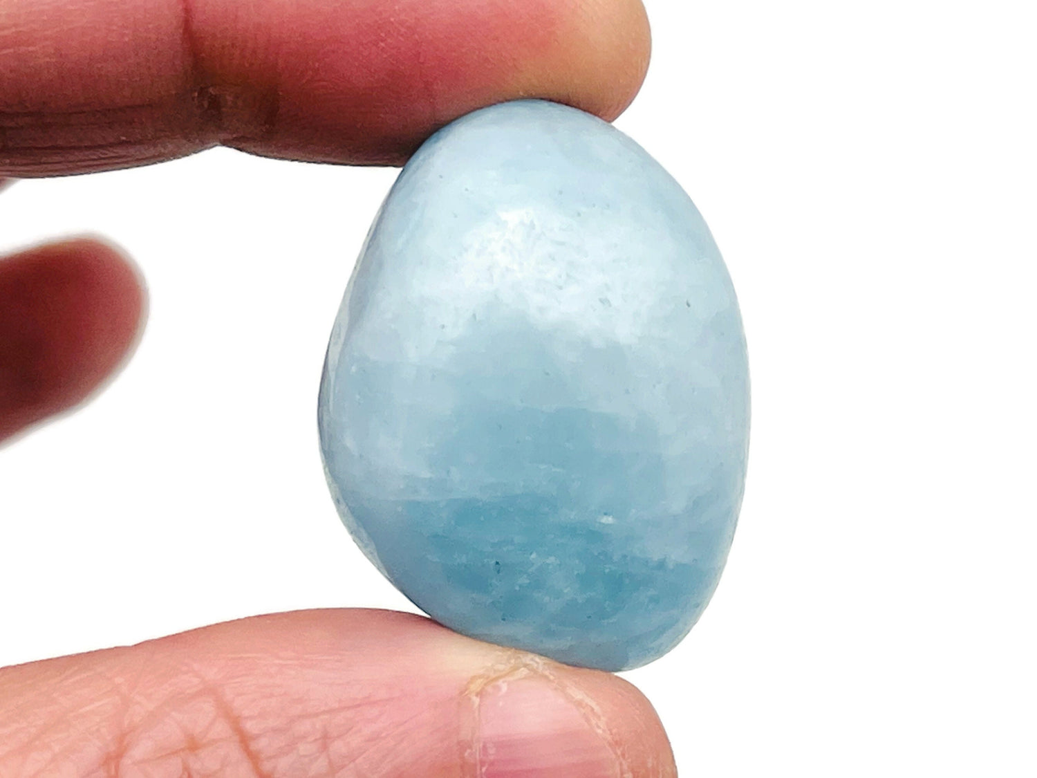 Smooth aquamarine tumbled stone from GemstoneGO, showcasing its light blue color and polished, rounded surface.