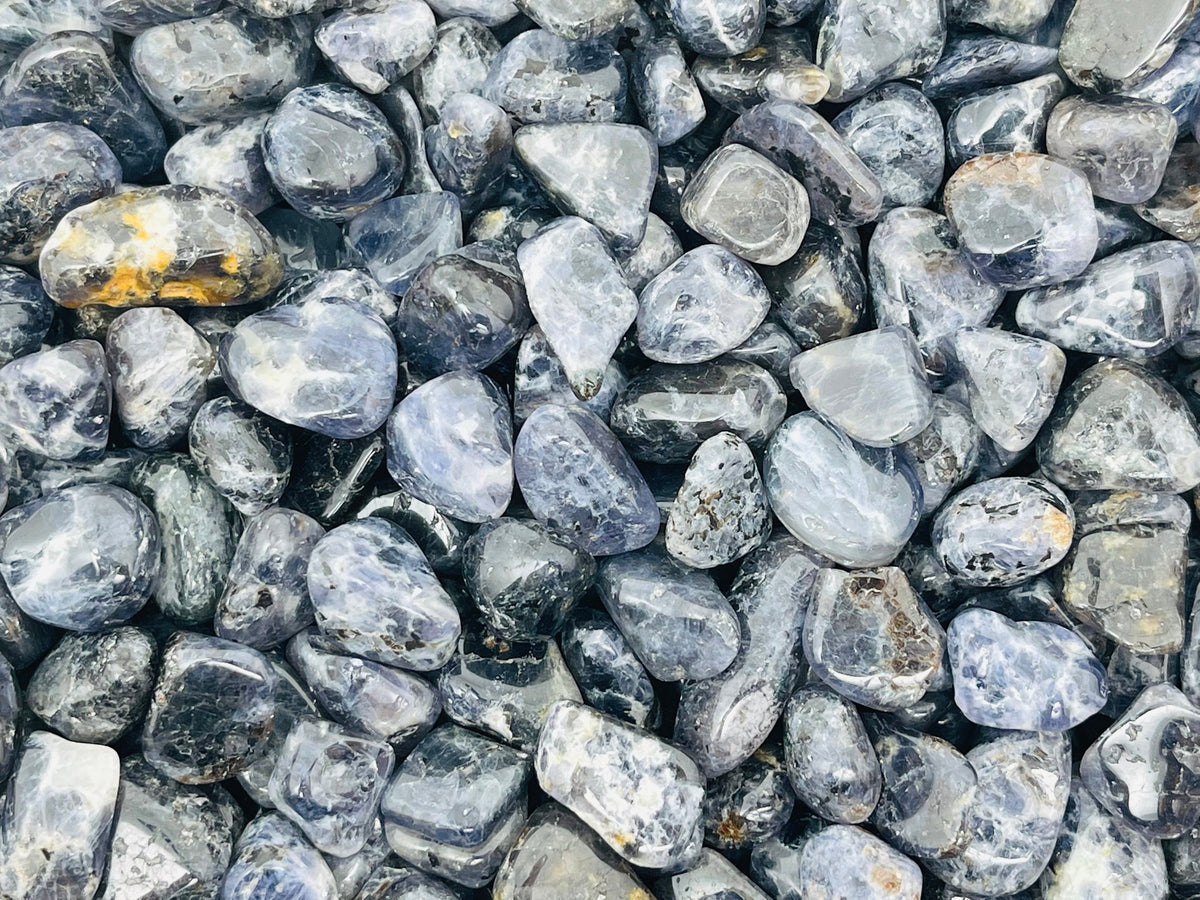 Semi-tumbled Iolite crystal chips in 7-12mm, natural gemstone bulk stones from GemstoneGO, showcasing deep blue and violet hues.