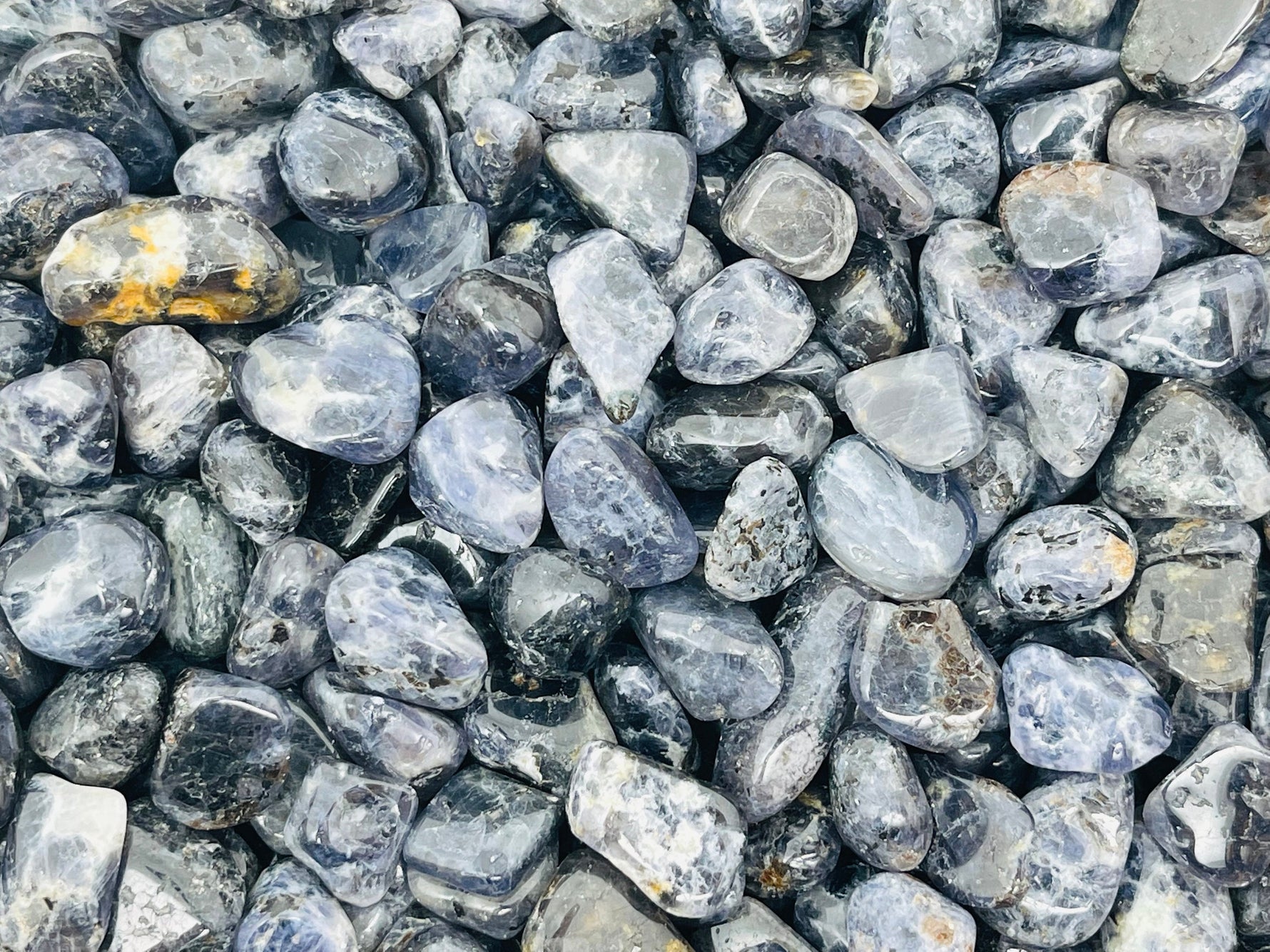 Semi-tumbled Iolite crystal chips in 7-12mm, natural gemstone bulk stones from GemstoneGO, showcasing deep blue and violet hues.