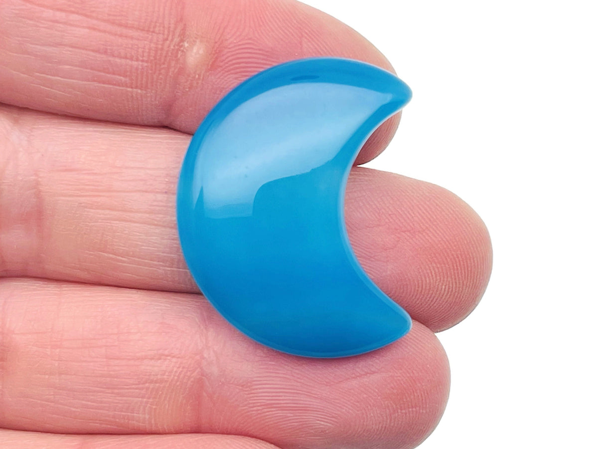 Blue agate gemstone moon pendant, 30mm, from GemstoneGO, showing a polished blue agate carved moon with natural patterns.
