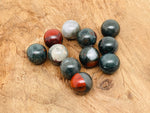 20mm African Bloodstone sphere gemstone with rich green and red mineral patterns, showcasing natural crystal ball beauty.