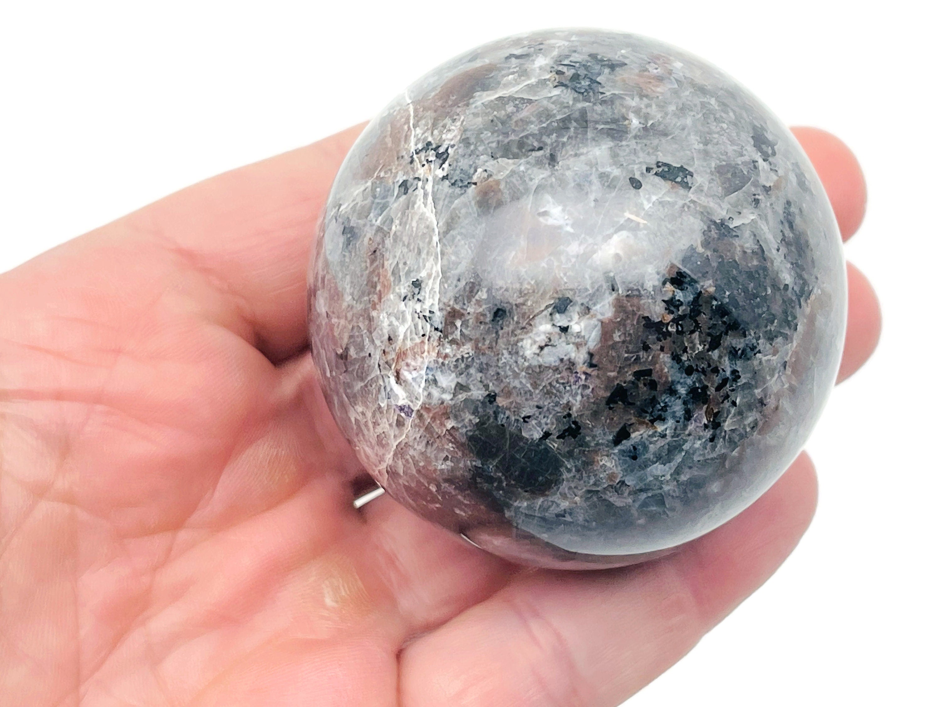 Yooperlite sphere gemstone from GemstoneGO, fluorescent sodalite crystal ball, 55-60mm with glowing blue fluorescence under UV light
