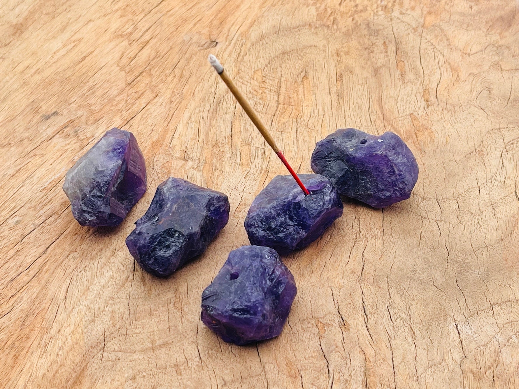 Handmade amethyst rough crystal incense holder with carved design, designed for holding incense sticks securely.