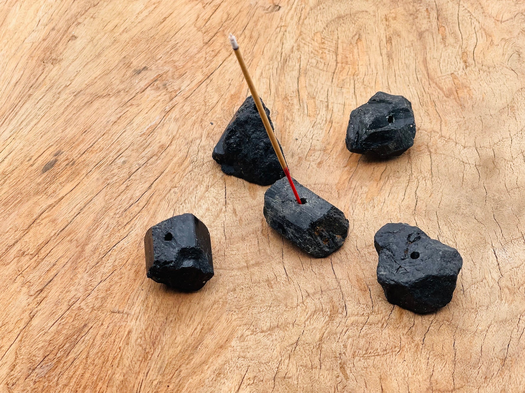 Black tourmaline rough crystal incense holder from GemstoneGO, handcrafted with natural carving, designed for incense sticks.