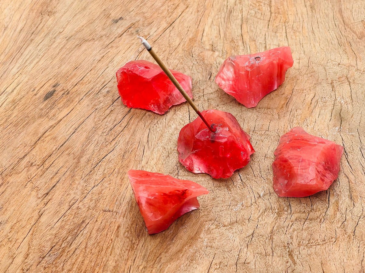 Cherry Quartz rough crystal incense holder with carved design, perfect for holding incense sticks in a handmade gemstone display.