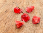 Cherry Quartz rough crystal incense holder with carved design, perfect for holding incense sticks in a handmade gemstone display.