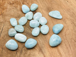 Aquamarine tumbled gemstone from GemstoneGO, smooth blue-green polished stone with natural variations and rounded shape.