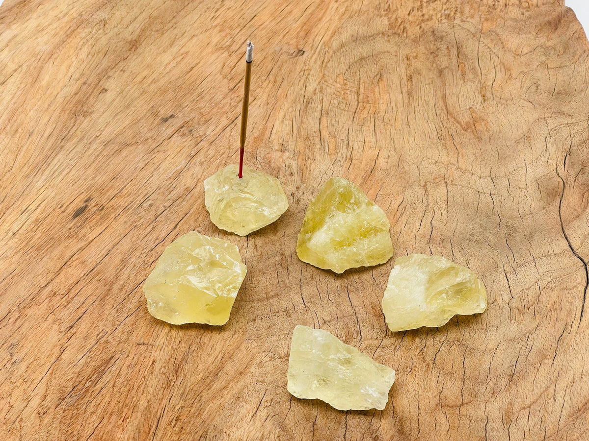 Handmade citrine rough crystal incense holder with carved design, ideal for holding incense sticks in a natural gemstone display.