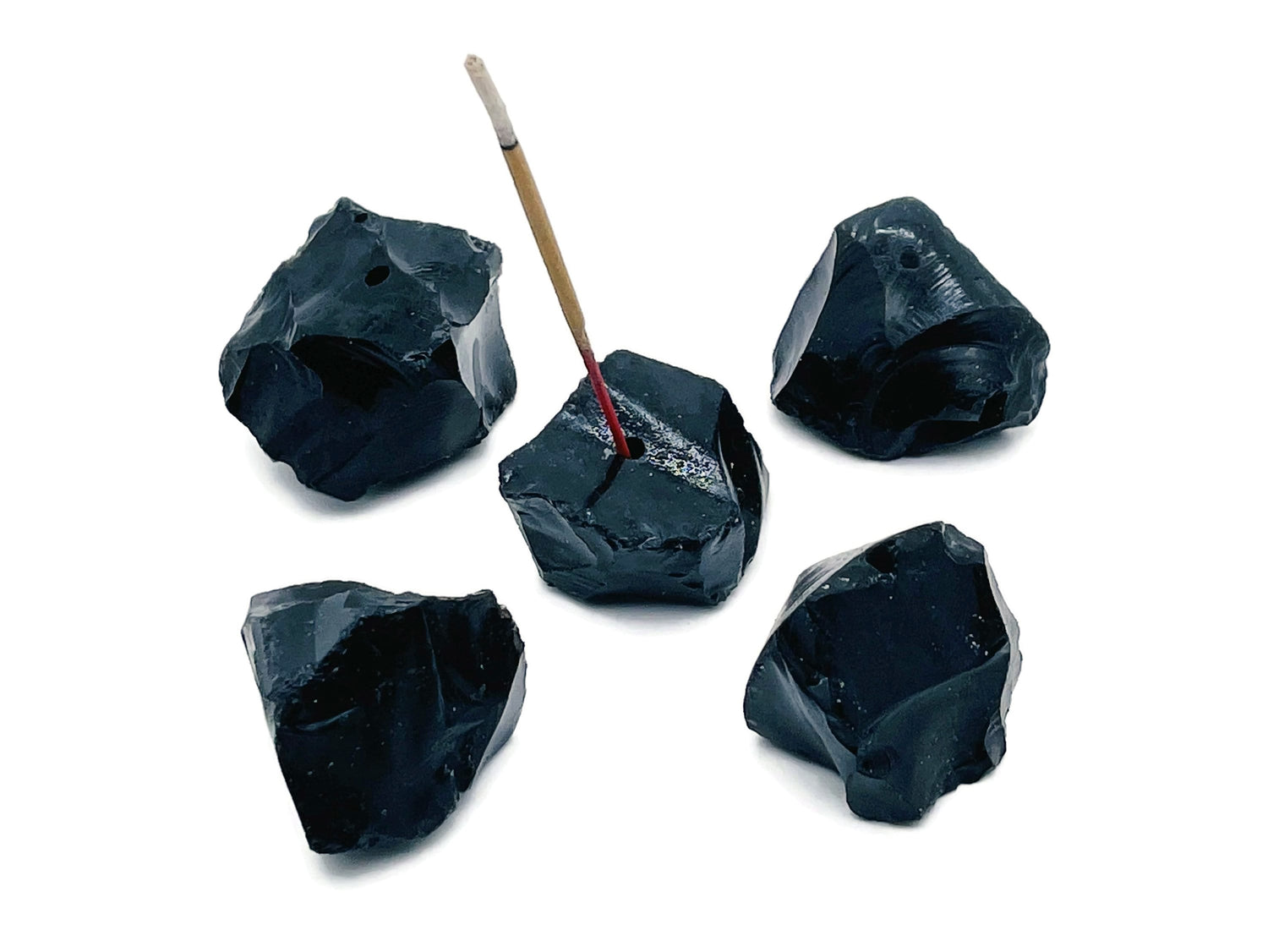 Handmade obsidian rough crystal incense holder with carved design, suitable for holding incense sticks.