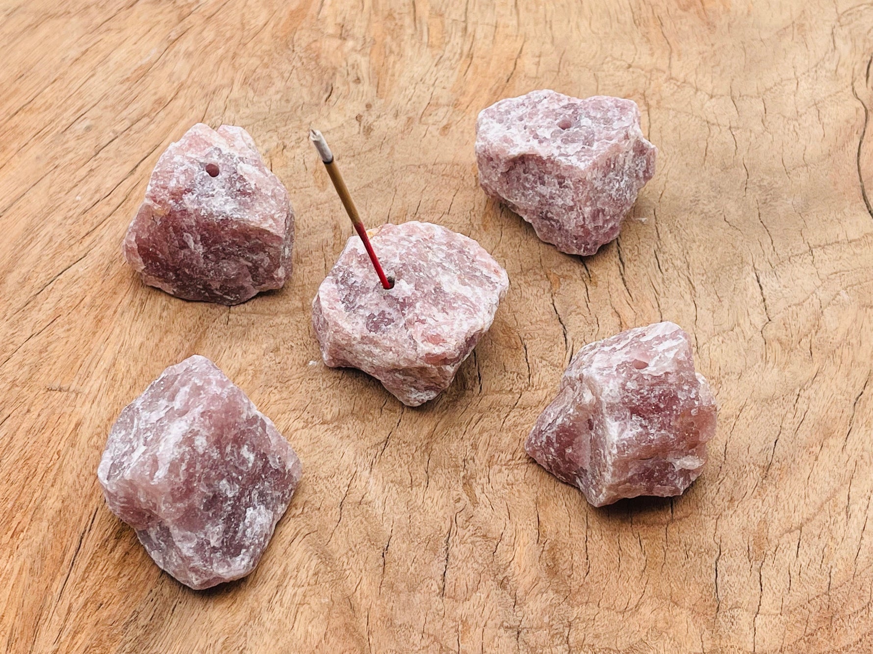 Handmade strawberry quartz rough crystal incense holder with carved design, ideal for holding incense sticks securely.
