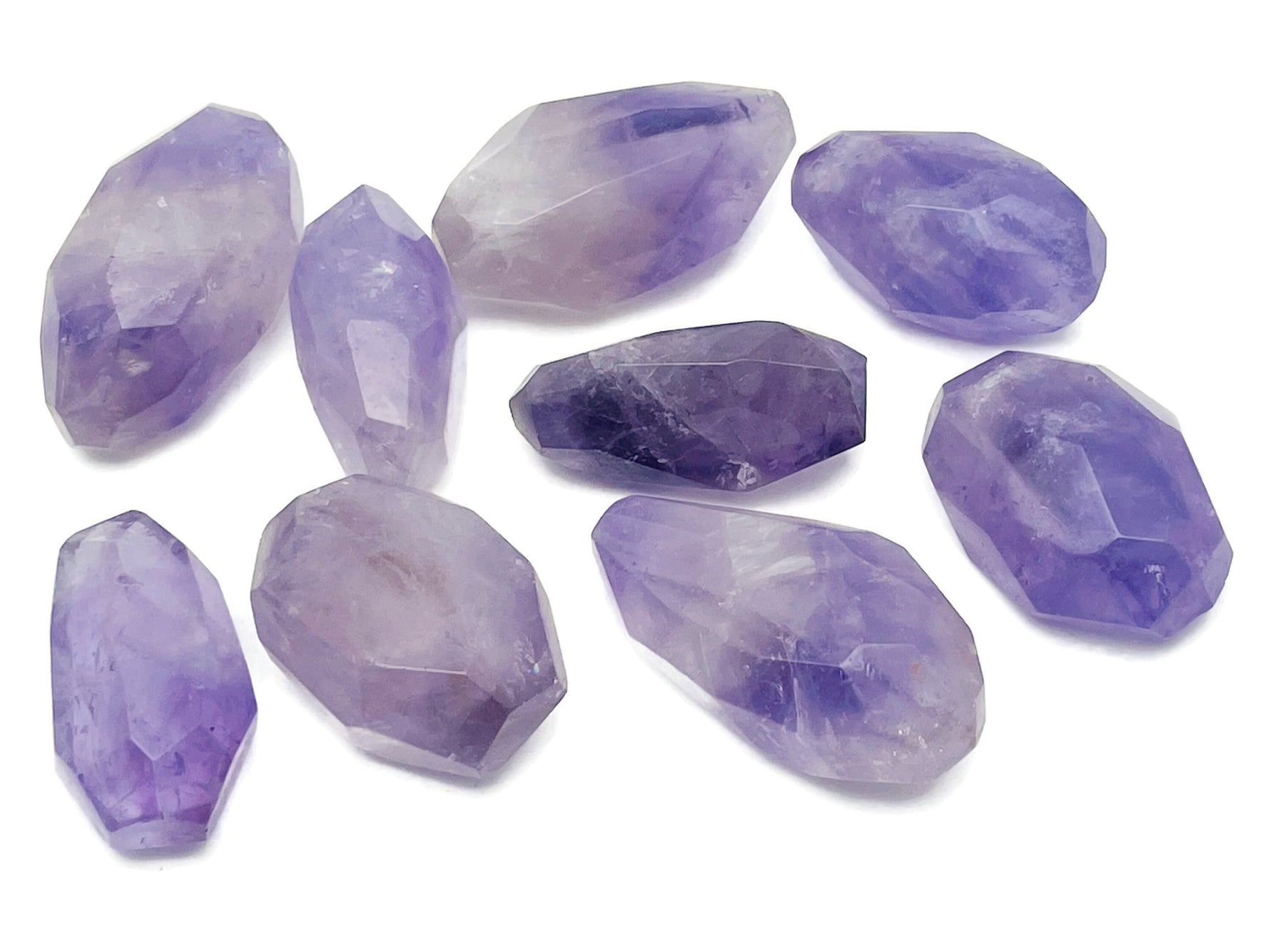 Amethyst double obelisk tower crystal from GemstoneGO, showing purple gemstone with natural crystal formations and polished surfaces.