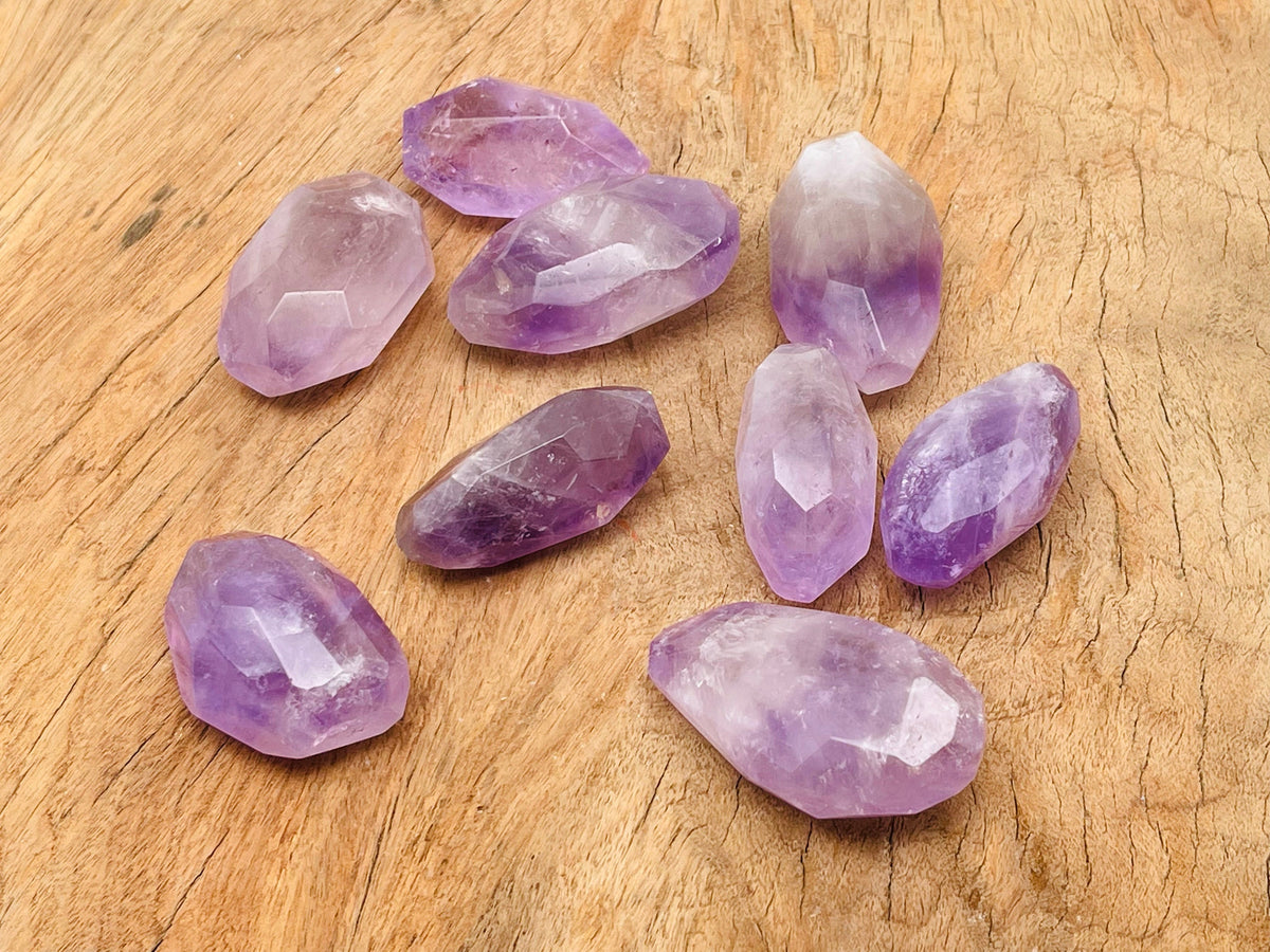 Amethyst double obelisk tower crystal from GemstoneGO, showing purple mineral structure and polished stone surface.