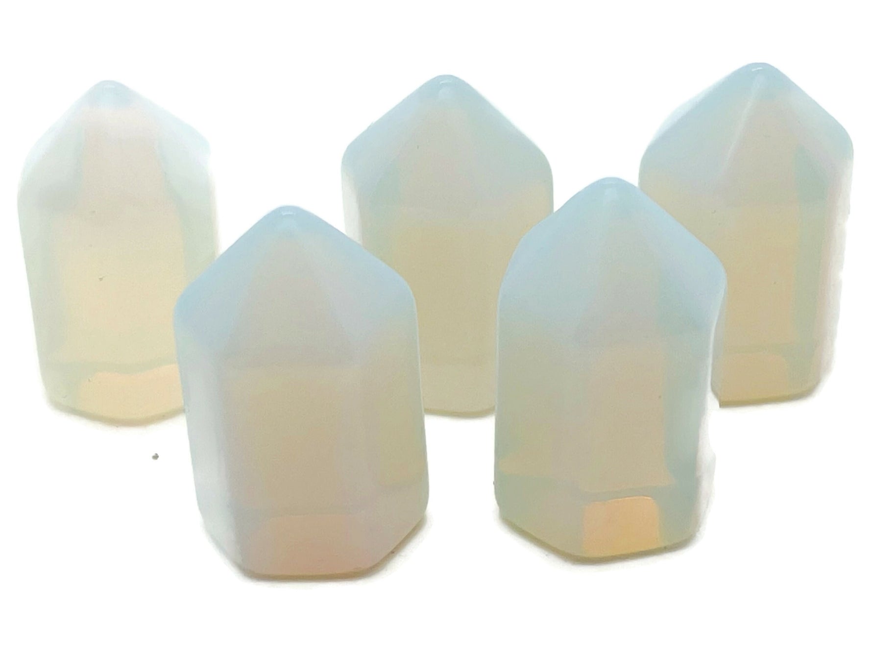 Opalite obelisk tower crystal from GemstoneGO, 25mm, showcasing a smooth, translucent white gemstone with subtle blue glow.