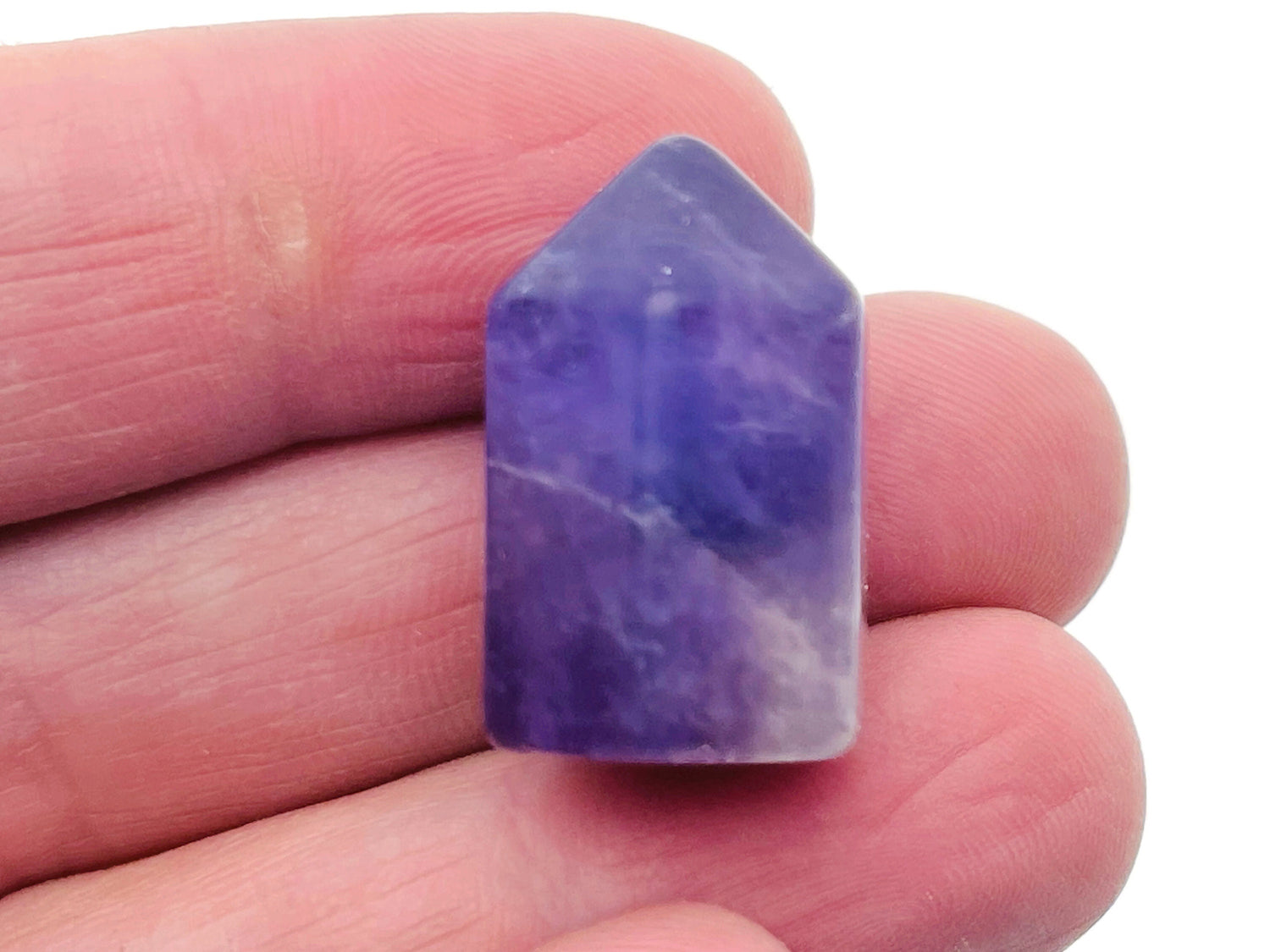 Amethyst obelisk tower crystal from GemstoneGO, 25mm tall, showcasing deep purple hues and pointed geometric shape.