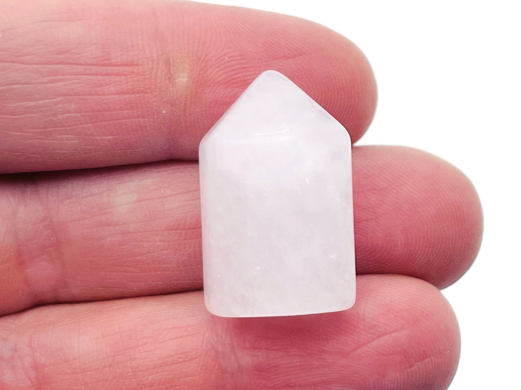 Clear Quartz obelisk tower crystal, 25mm, from GemstoneGO, showcasing a translucent, polished pointed gemstone.