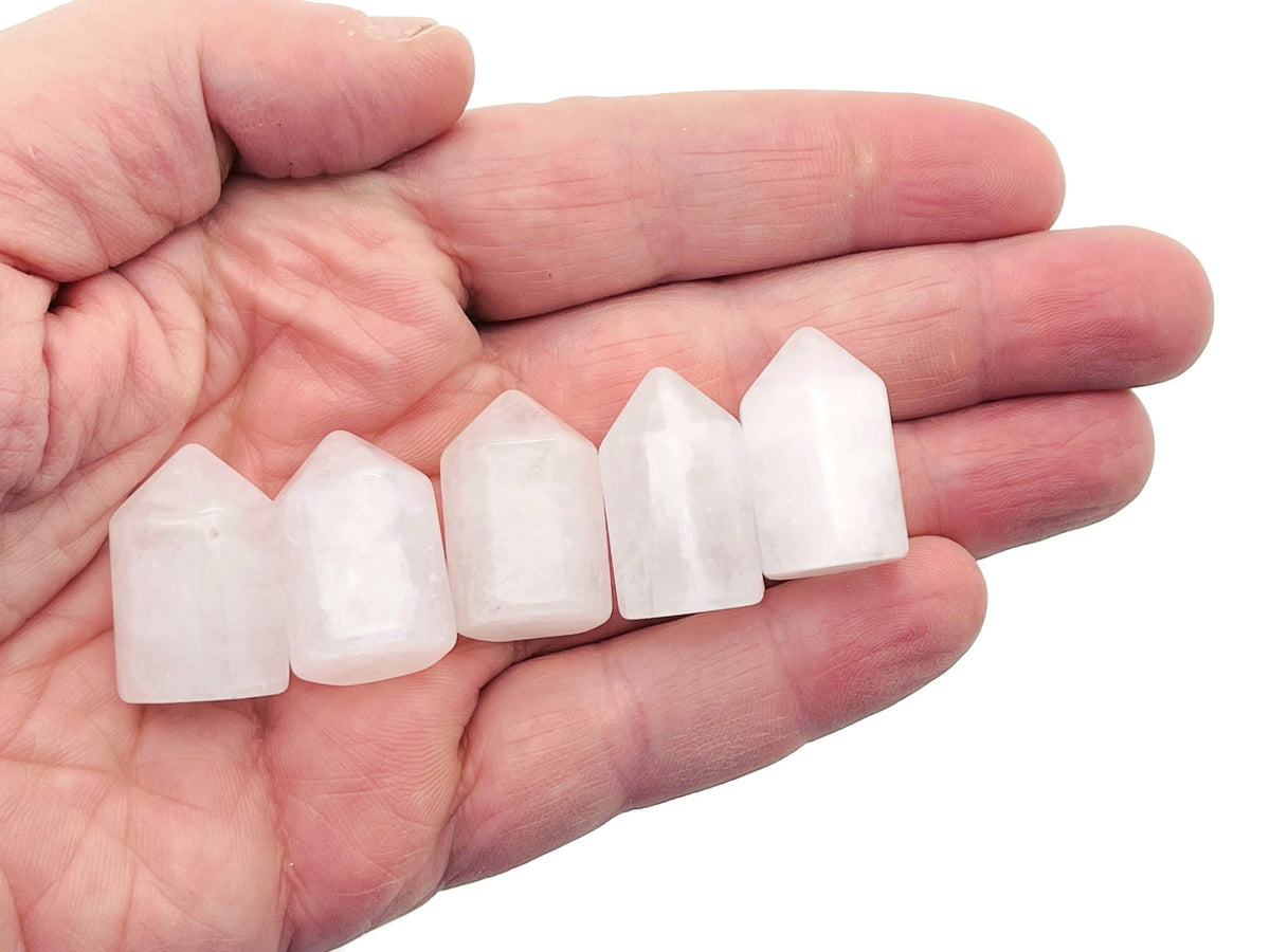 Clear quartz obelisk tower crystal, 25mm, from GemstoneGO, showing a transparent, polished gemstone with natural facets and pointed top.