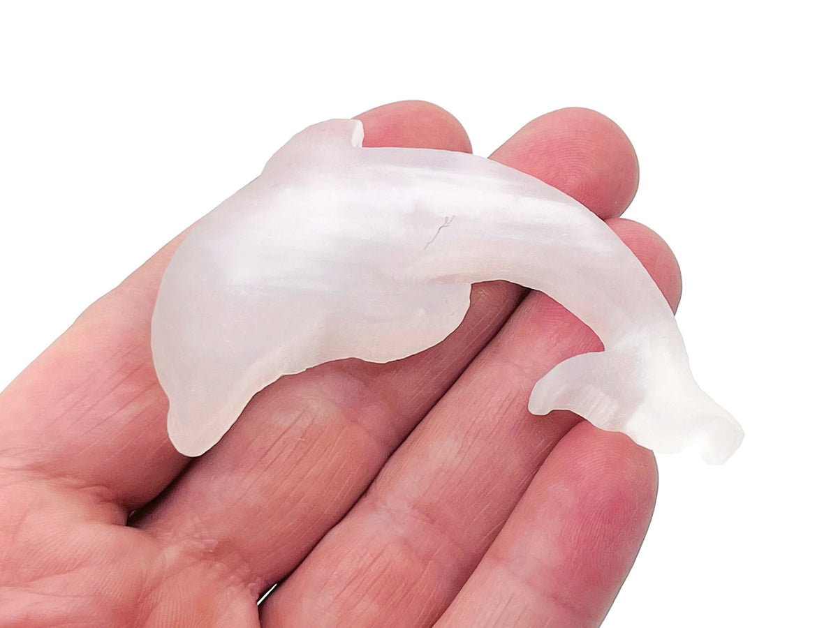 Selenite dolphin carving gemstone by GemstoneGO showcasing a smooth, polished dolphin-shaped crystal with natural white and translucent tones.