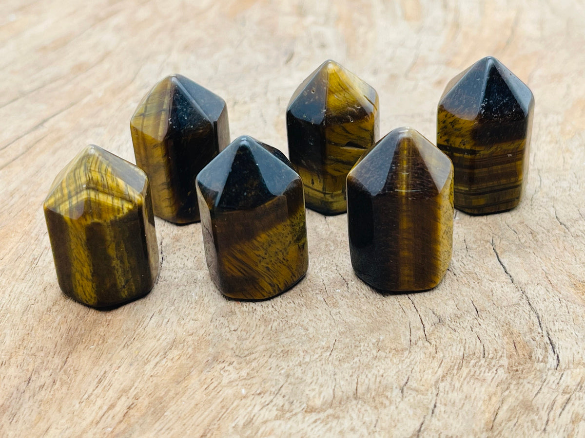 Tiger Eye Obelisk Tower crystal 25mm from GemstoneGO, showcasing the polished, golden-brown stone with natural banding details.