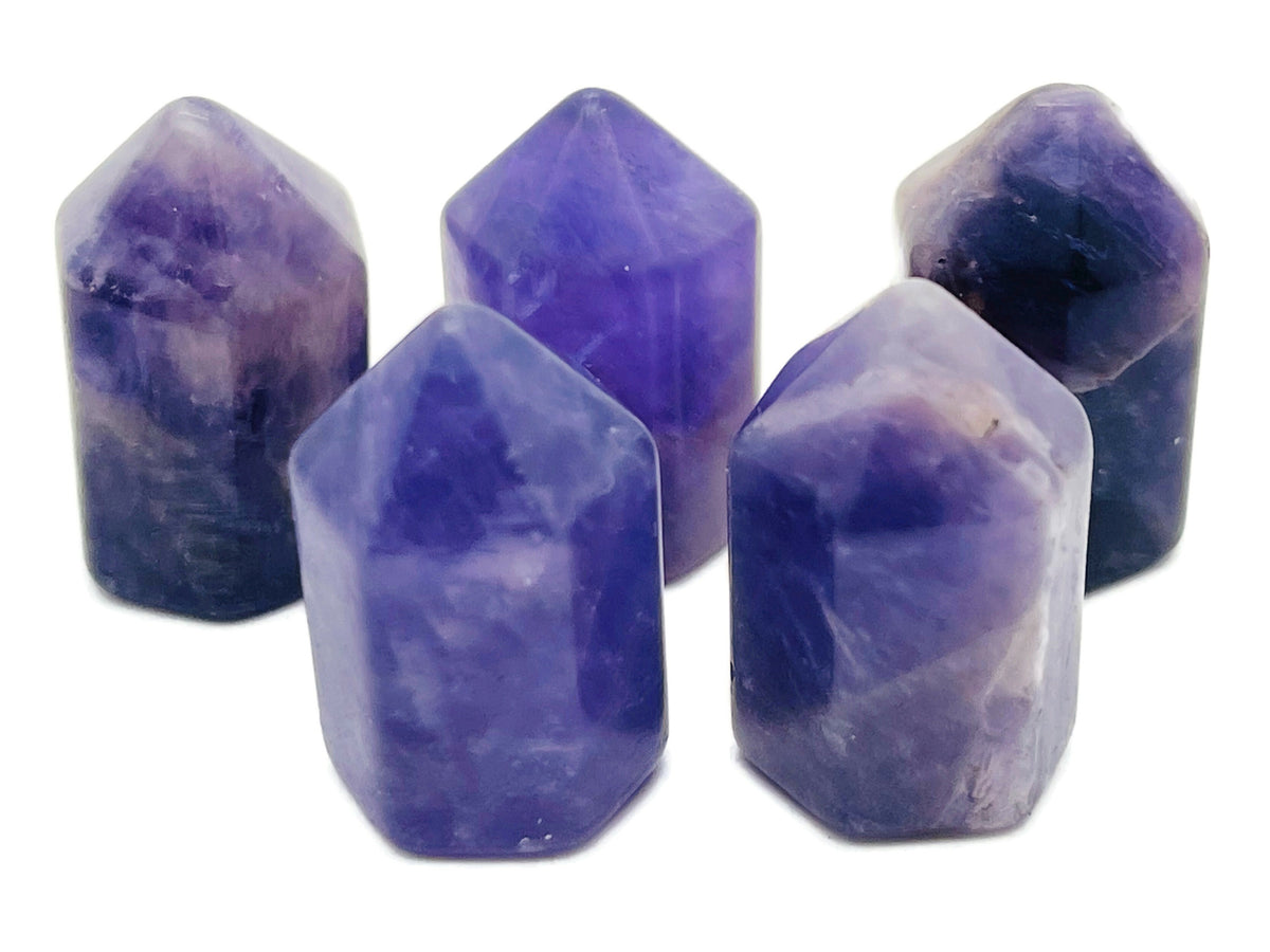 Amethyst obelisk tower crystal, 25mm, from GemstoneGO, showing purple gemstone with natural crystal formations.