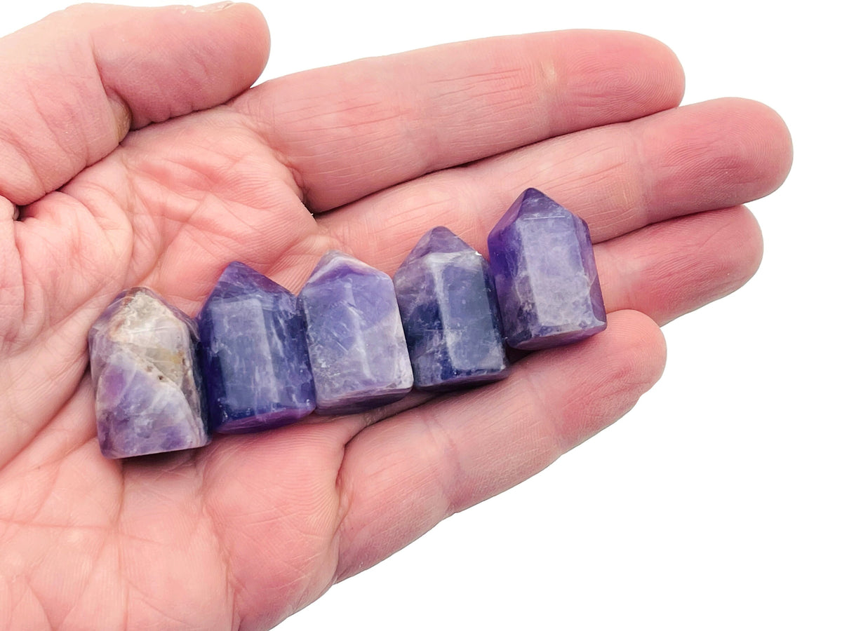 Amethyst obelisk tower crystal from GemstoneGO, 25mm tall, showcasing purple quartz with natural facets and pointed tip.