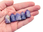Amethyst obelisk tower crystal from GemstoneGO, 25mm tall, showcasing purple quartz with natural facets and pointed tip.
