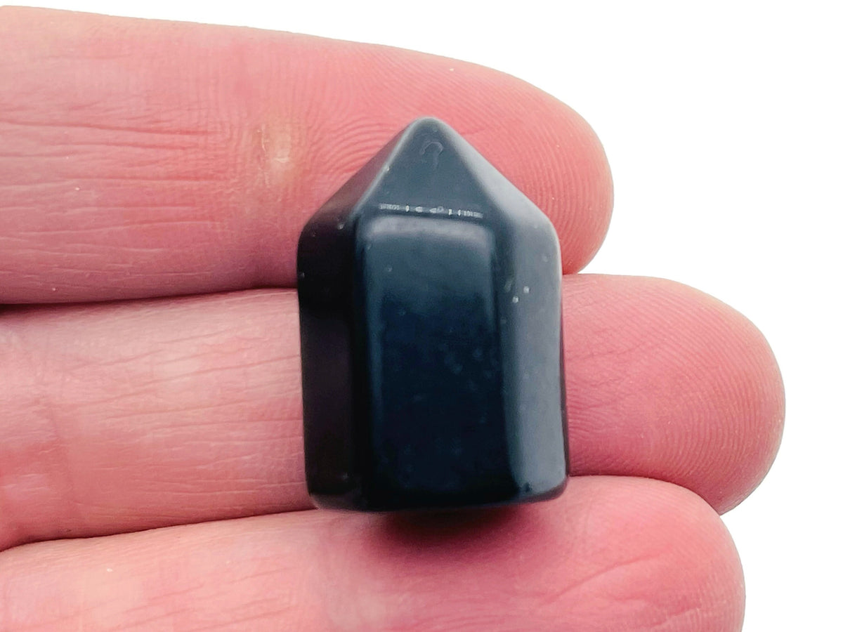 Polished 25mm black obsidian obelisk tower crystal from GemstoneGO, with smooth surface and pointed top.