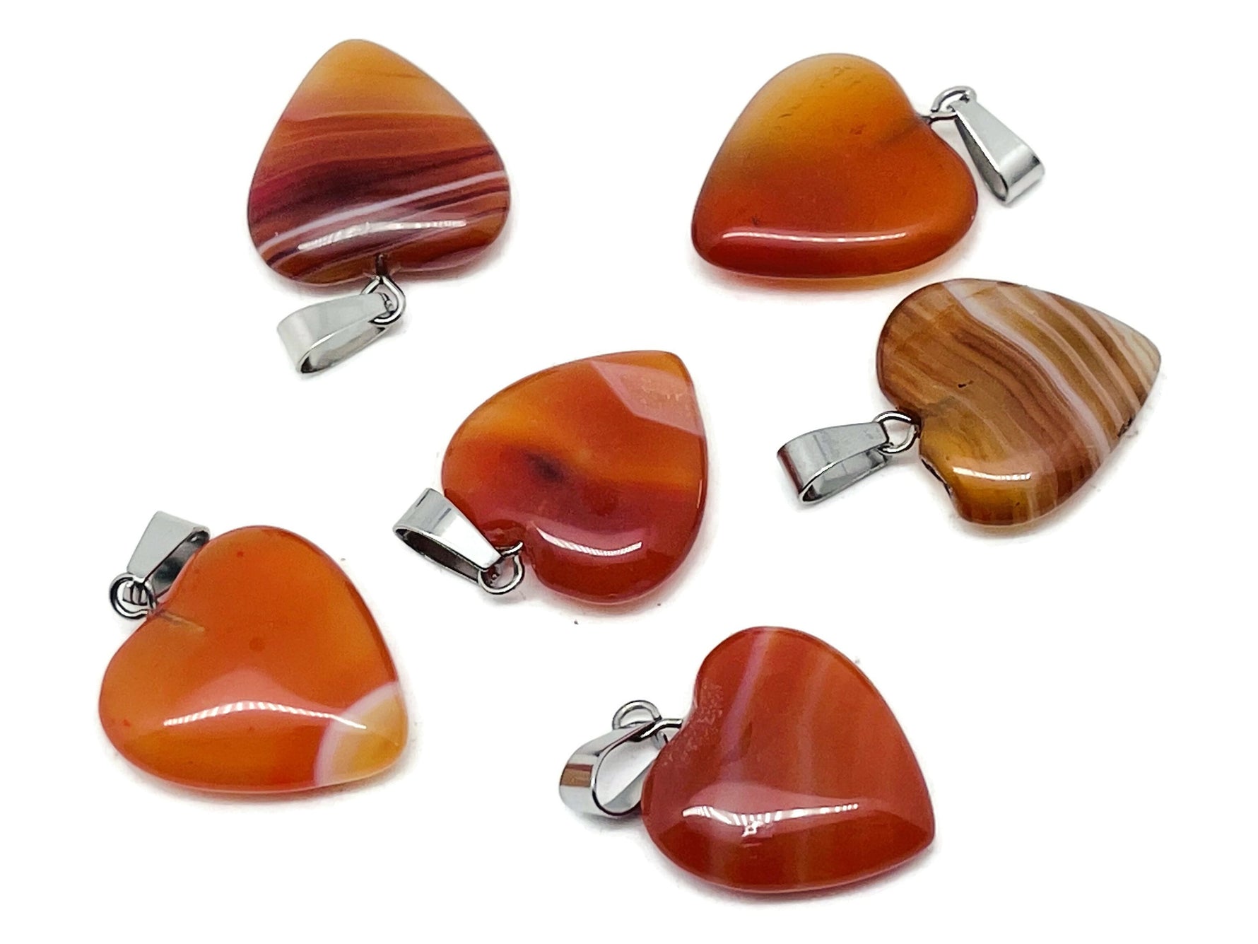 Carnelian heart pendant by GemstoneGO featuring a mini crystal design, perfect for healing and gifting.