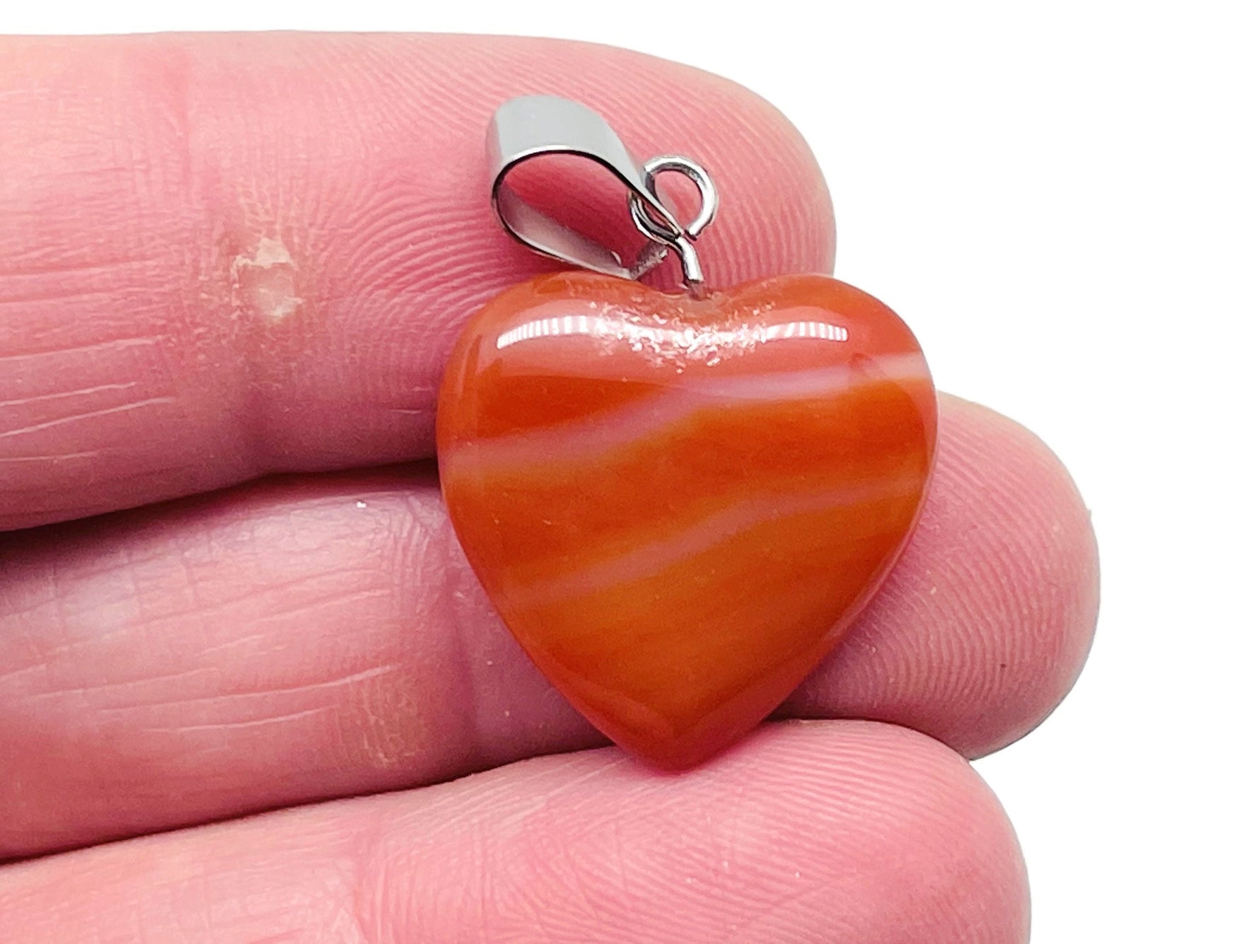 Carnelian heart-shaped crystal pendant from GemstoneGO, featuring a mini healing gemstone pendant with a polished finish.