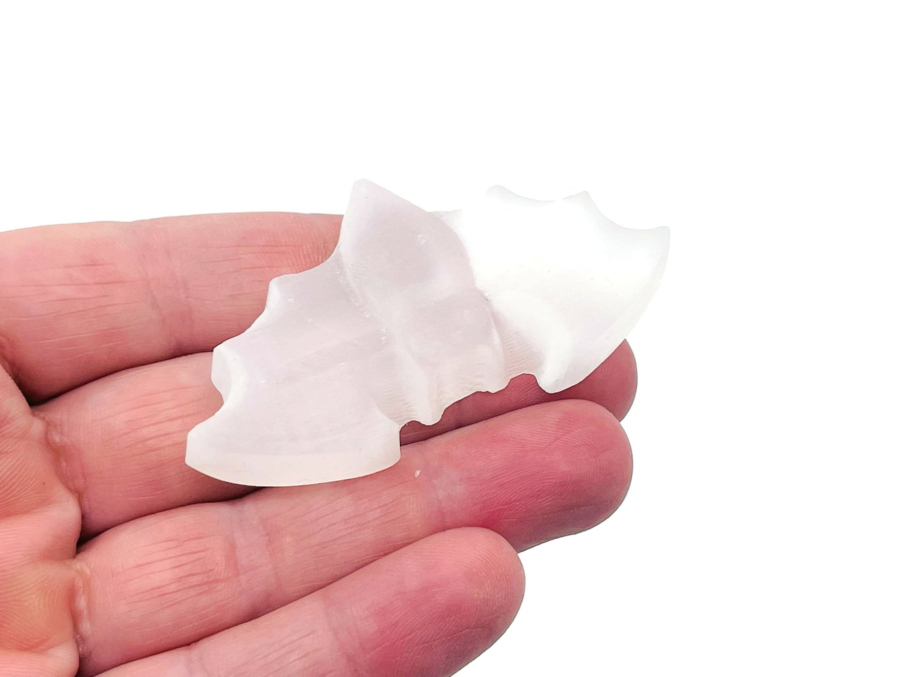 Selenite bad carving gemstone from GemstoneGO showing a smooth, carved selenite piece with natural white and translucent features.