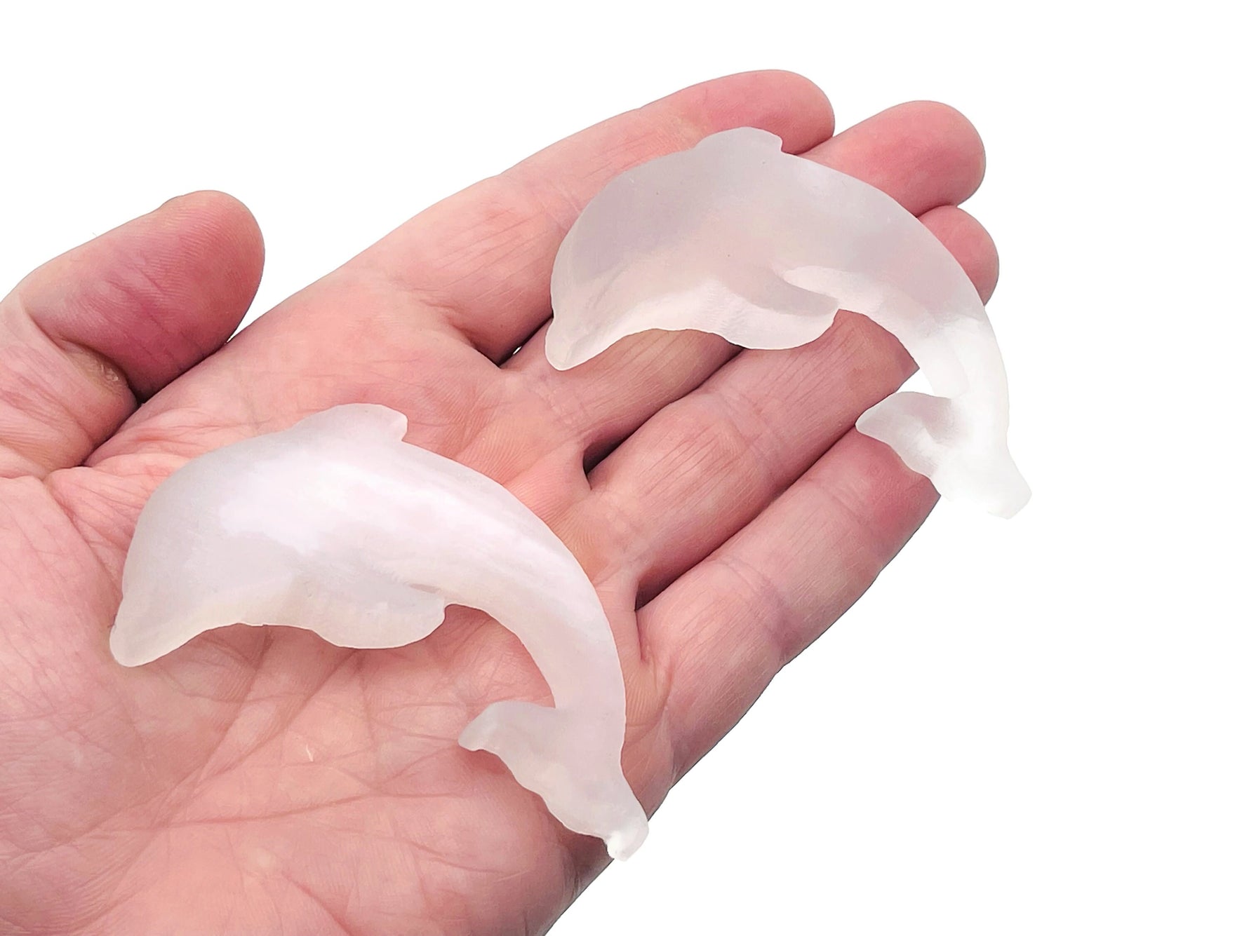 Selenite dolphin gemstone carving by GemstoneGO, smooth white sculpture featuring a dolphin shape with carved details.