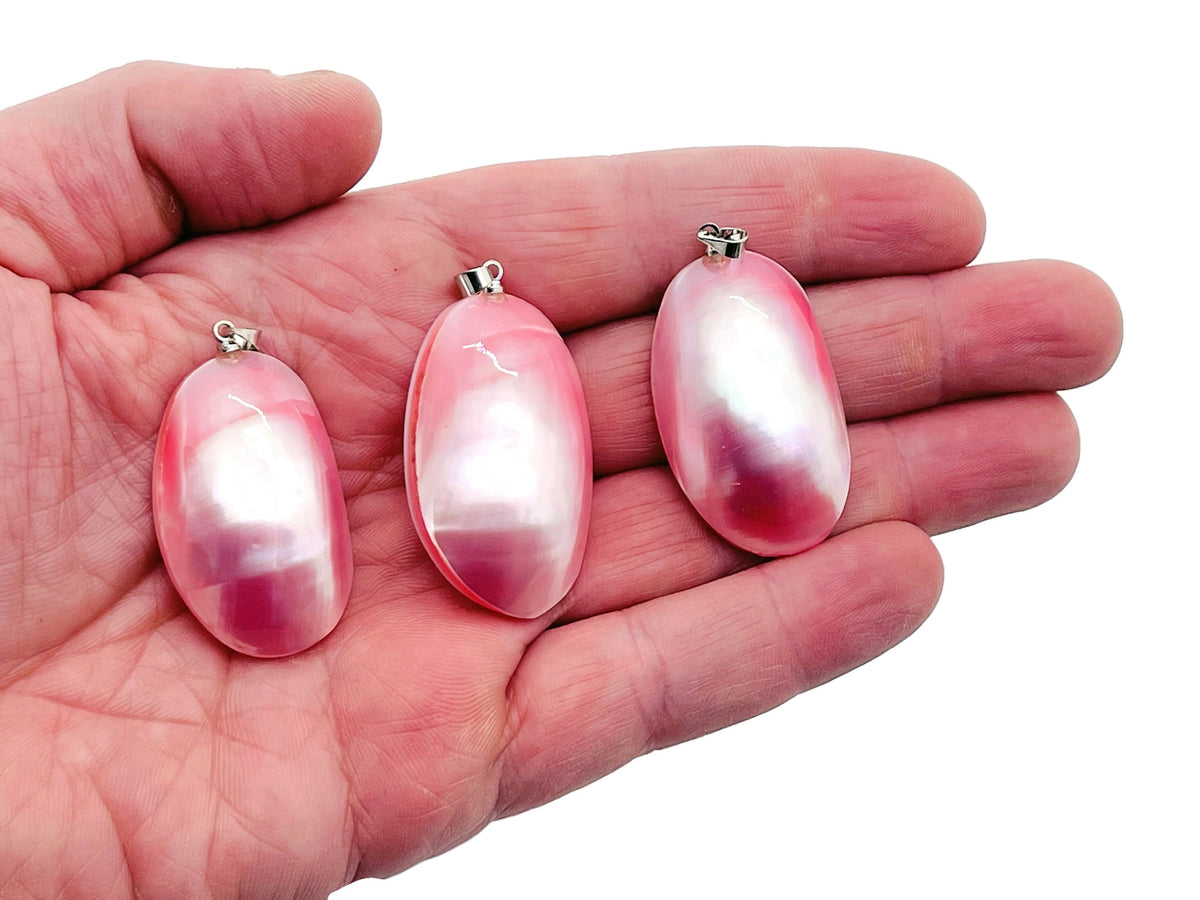 Pink natural pearl pendant from GemstoneGO, shown with a jewelry-making crystal in a bulk package.