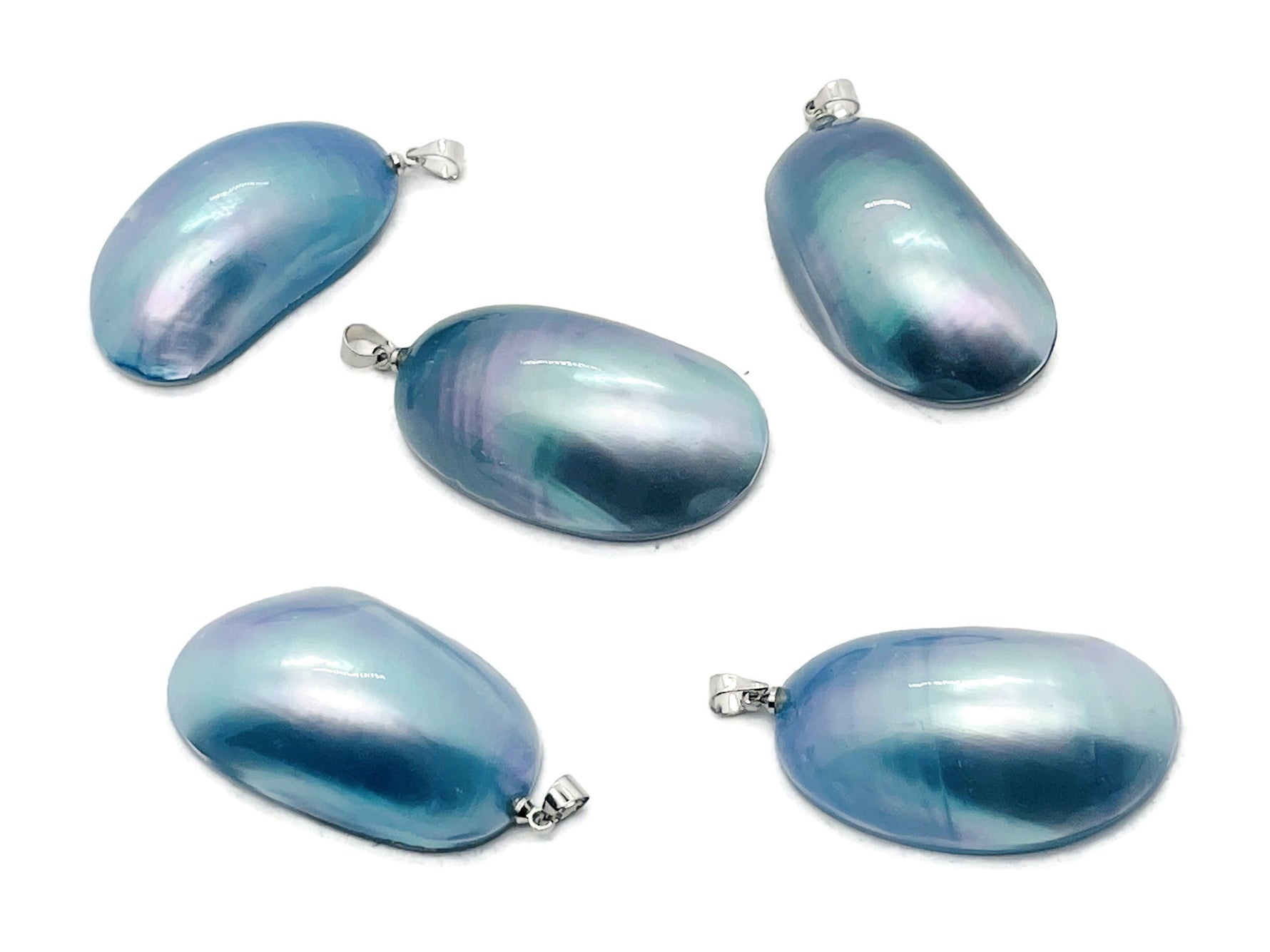 Blue natural pearl pendant from GemstoneGO, showcasing a smooth, round gemstone for jewelry making in a close-up shot.