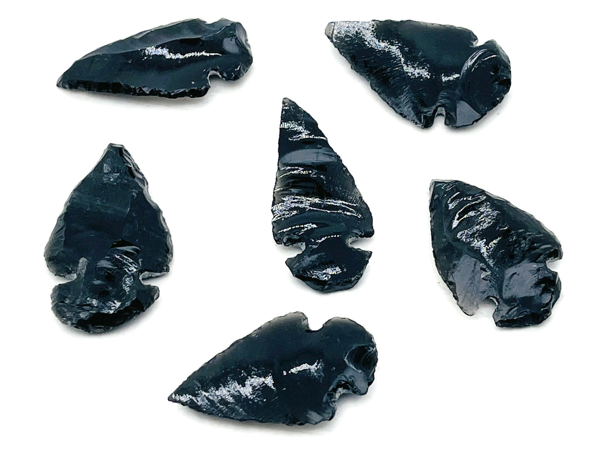 Black obsidian arrowhead carving gemstone with pointed spear shape and detailed craftsmanship, perfect for collection or jewelry making.