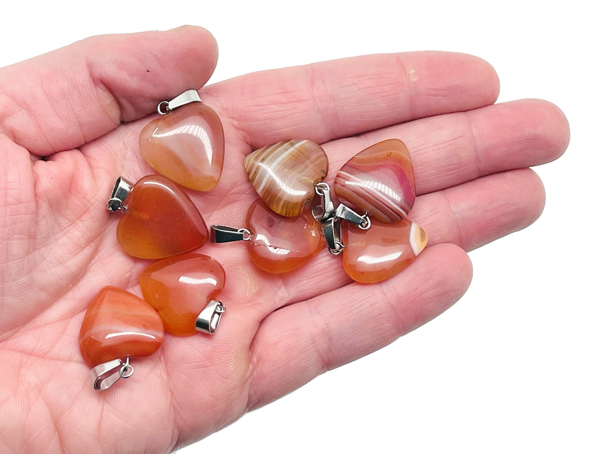 Carnelian heart pendant with crystal accents from GemstoneGO, showcasing its vibrant orange gemstone and delicate design.