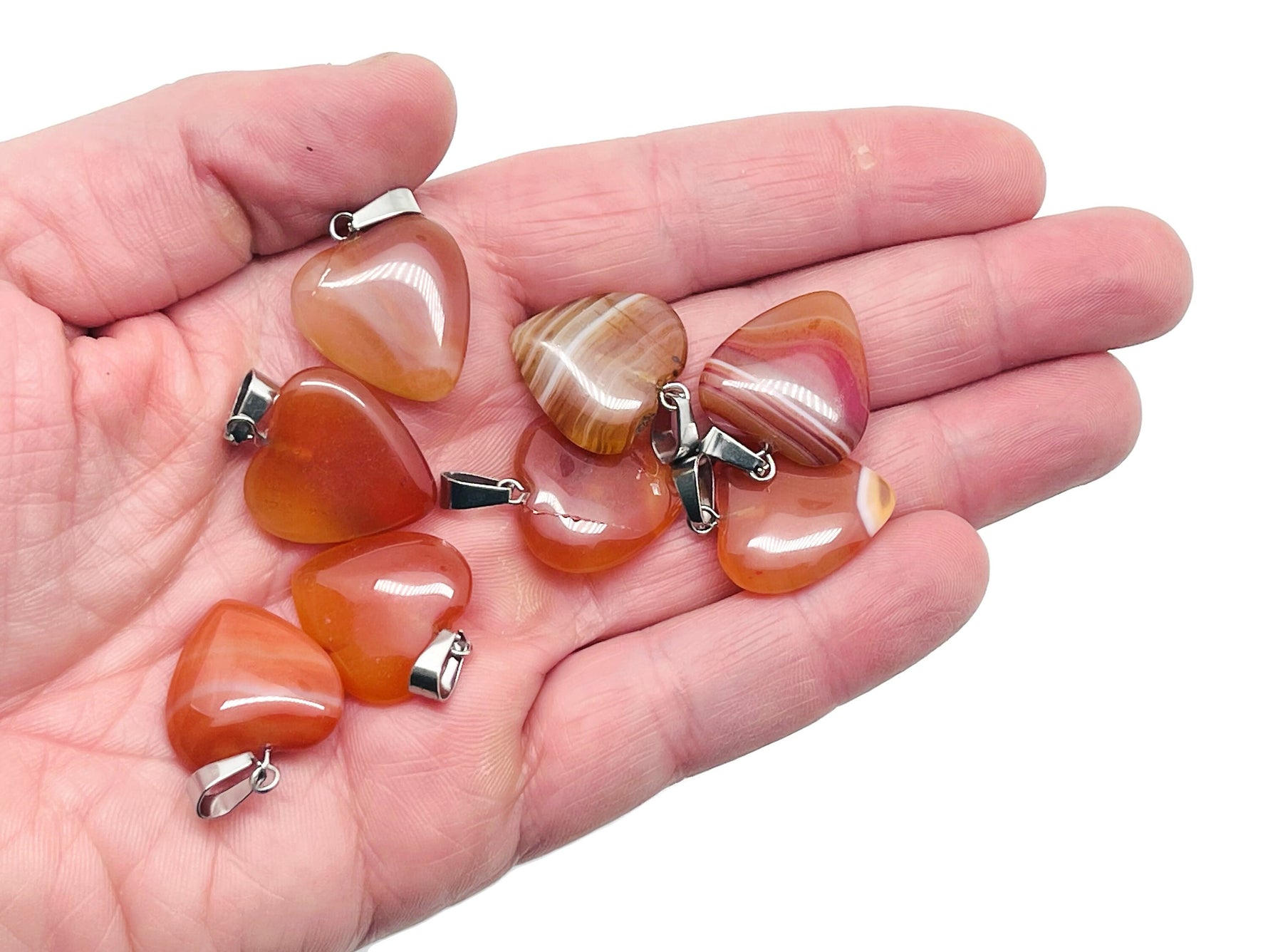 Carnelian heart pendant with crystal accents from GemstoneGO, showcasing its vibrant orange gemstone and delicate design.