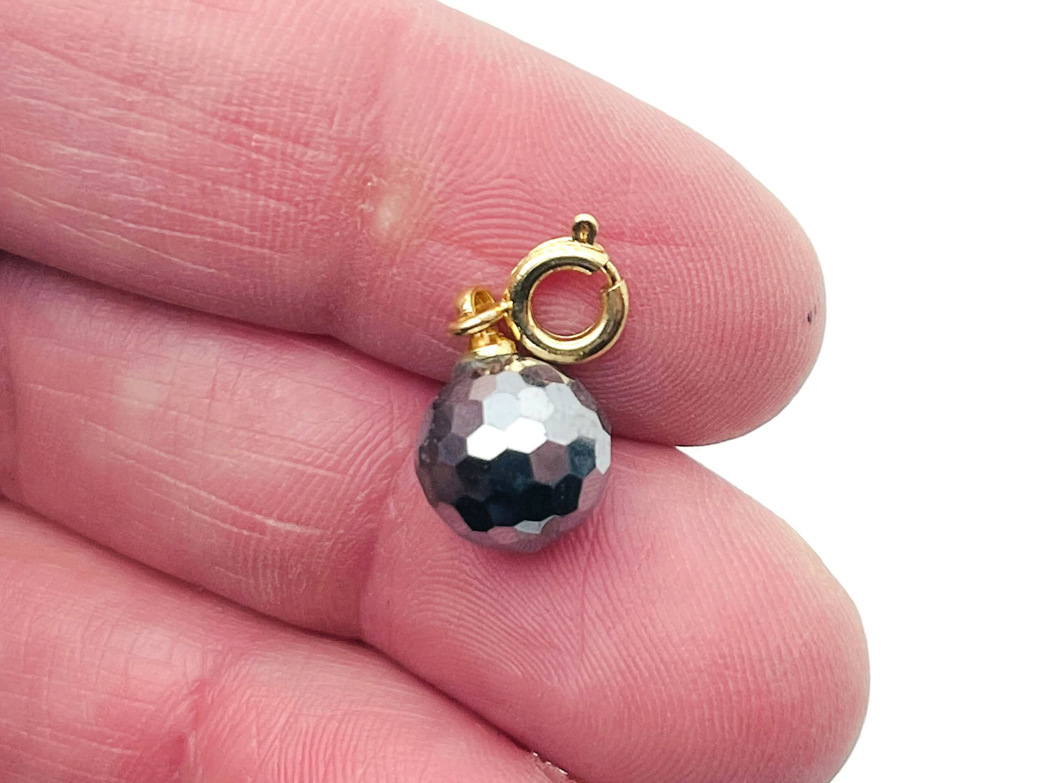 Terahertz gemstone pendant from GemstoneGO, showcasing a polished, vibrant gemstone with a silver bail for jewelry making.