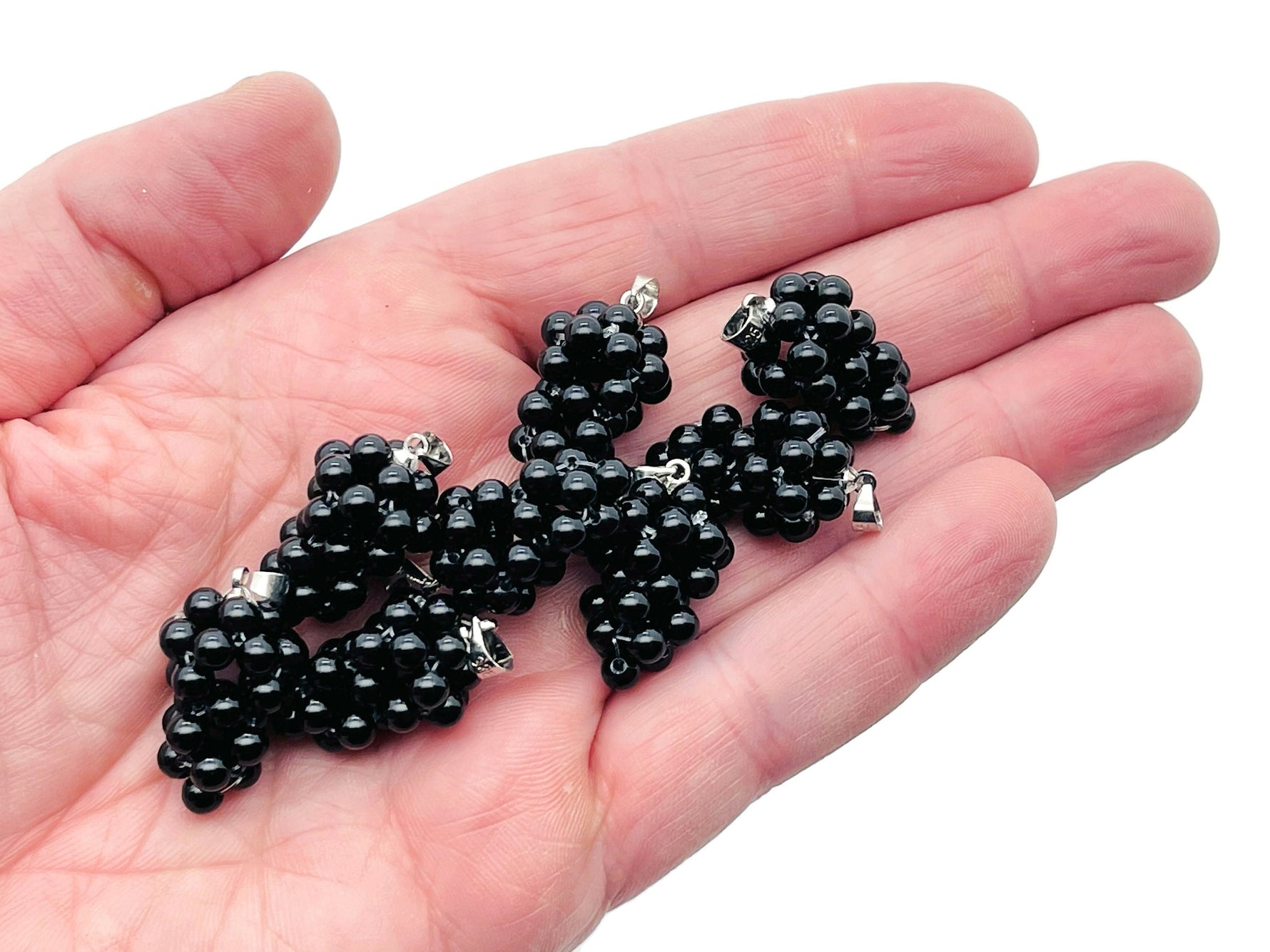 Obsidian and grape crystal pendant by GemstoneGO featuring a cluster of sparkling crystal grapes on a silver chain.