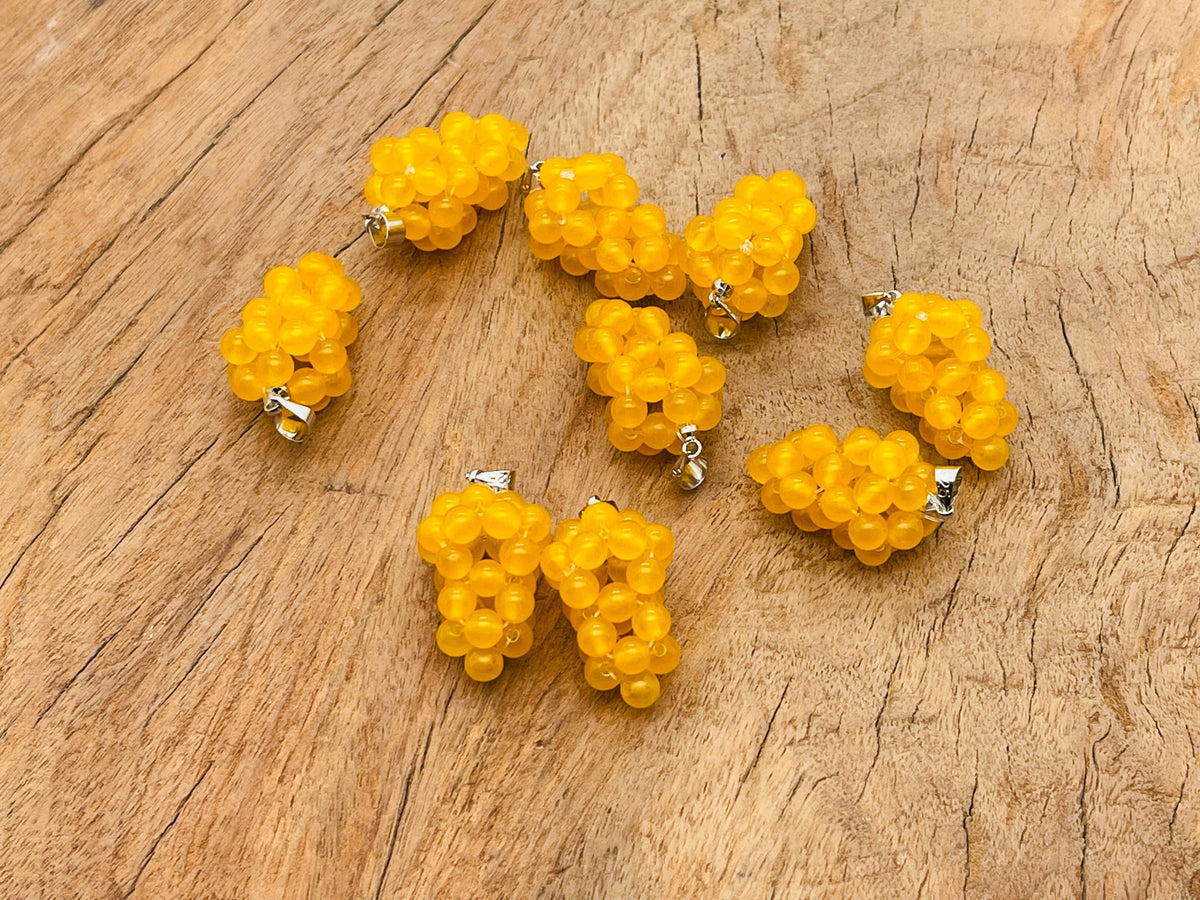 Yellow agate and grape-shaped crystal pendant by GemstoneGO, featuring a vibrant yellow gemstone and intricate crystal details.