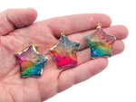 Rainbow Aura Star Crystal Pendant from GemstoneGO featuring pink, yellow, and blue hues, displayed as a loose crystal gemstone.